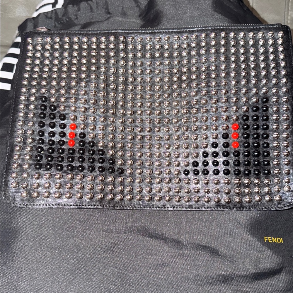 Preloved Fendi monster stuffed black clutch silver, black n red stud excellent.